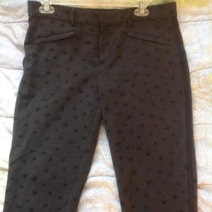 Grey ankle-length work slacks with black stars